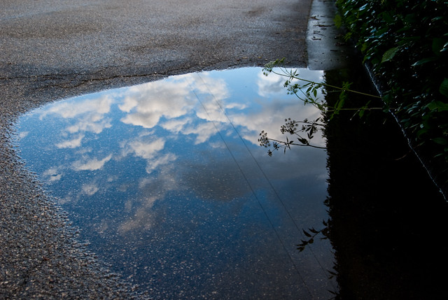 puddle reflecting clouds